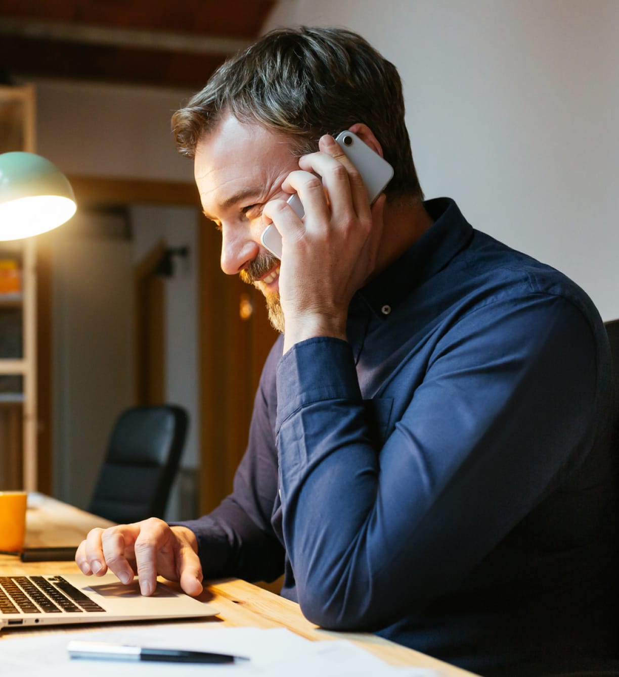 man-desk-phone-smile