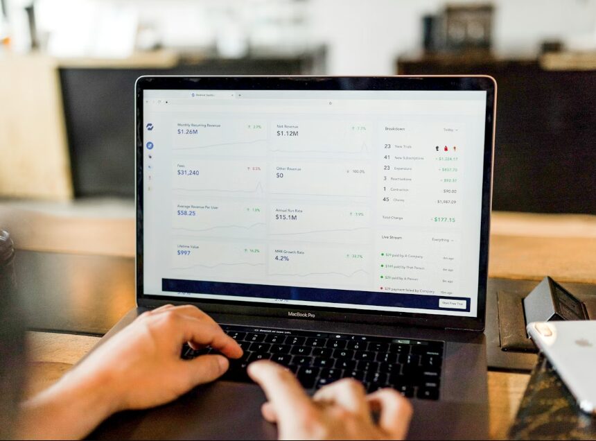 Person using laptop to view financial analytics dashboard